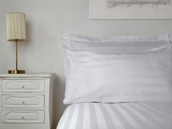 Optima linen uses chemicals to reduce creases and is made with a stain-release system