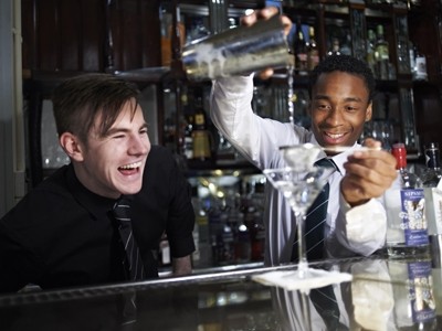 Gerard Lenehan, a bar tender at Brown's Covent Garden gives tips to apprentice Shamir Reid-Thomas who has been recruited at Brown's Islington