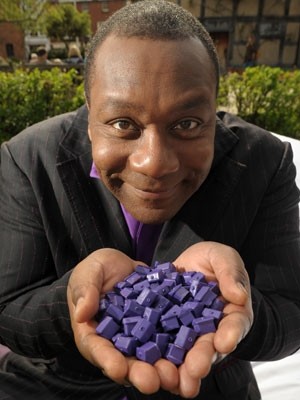 Lenny Henry holding 600 Premier Inn Monopoly Hotels, following the opening of the 600th site