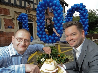 Pete Ayres, general manager of the Chase Hotel, with the Spirit Pub Company head of brand for John Barras, Sebastian Leheup-Jones, celebrate the opening of the 100th John Barras pub with a team member