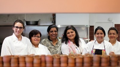 Khan (third from left) and her kitchen team