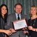 Mark Lewsey, director of communications for the Corinthia Hotel, London (centre), collects one of the hotel's two Hotel Marketing Association (HMA) awards from Hana Lear, client services director at American Express (left) and Linda Moore, HMA chairman (right)