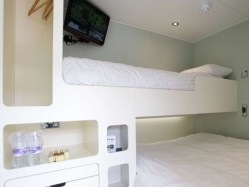 The Snoozebox bedrooms at Stoneleigh Park comprise a double bed together with a single bed, flat screen TV, Wi-Fi and a safe