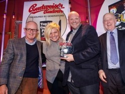 Tom Kerridge and his wife Beth pick up their award from Budvar Budweiser UK marketing controller Ian Moss (left) and host Matthew Fort
