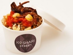Koshari is a vegetarian dish consisting of lentils, rice and pasta topped with spicy tomato sauce, caramelised onion and boiled chickpeas