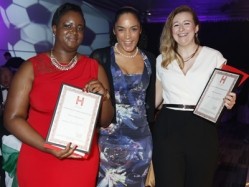 Alissia Clarke (left) and Jodie Britton (right) receive their prizes from Esher Williams (centre). 
