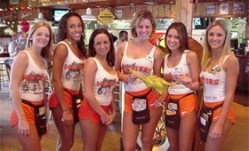 The Hooters uniform consists of orange shorts and a white tank top